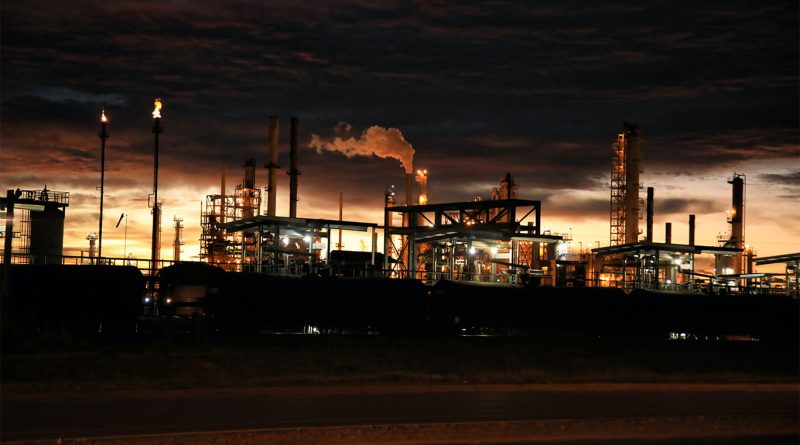 Image of a factory site at night time to support pump manufacturing article