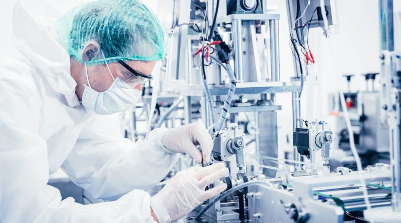 Image of a science professional working in a laboratory on medical equipment to support medical device manufacturing article