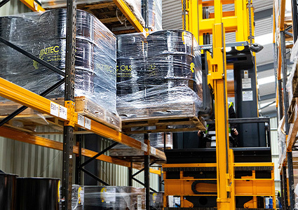 Large metal barrels of lubricant on a pallet