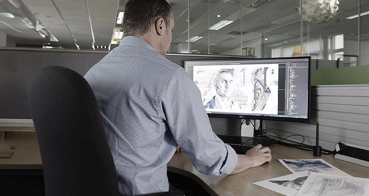 Technician designing currency on PC