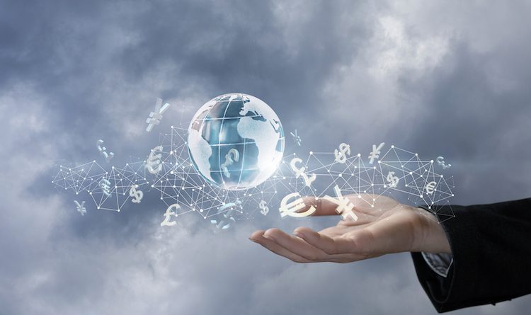 A global map surrounded by digit connections combined with international currency units is hanging above the businesswoman's hand. The concept is the International cashflow principle.