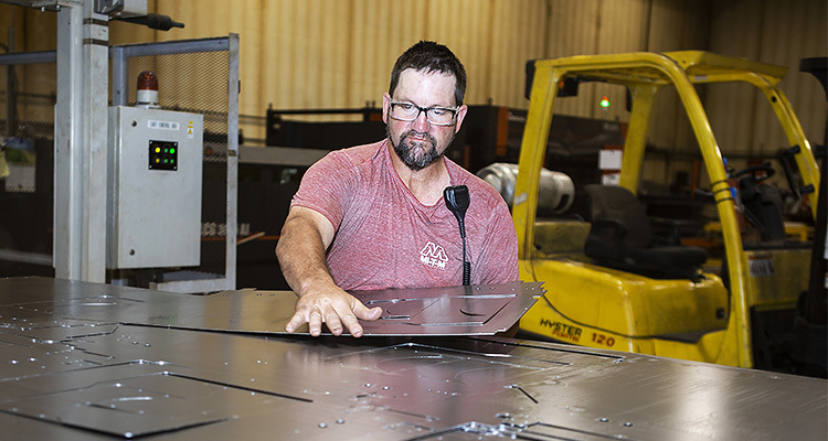 Worker inspecting steel sheet