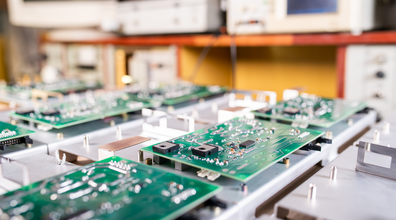 Close-up computer green microcircuits to support PCB manufacturing article
