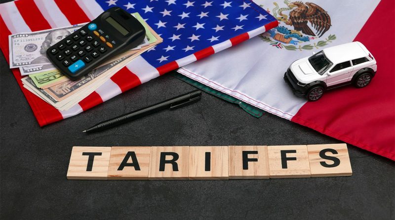 US and Mexican flags next to each other with 'Tariffs' sign and model cars and calculators to support 100% tariffs article