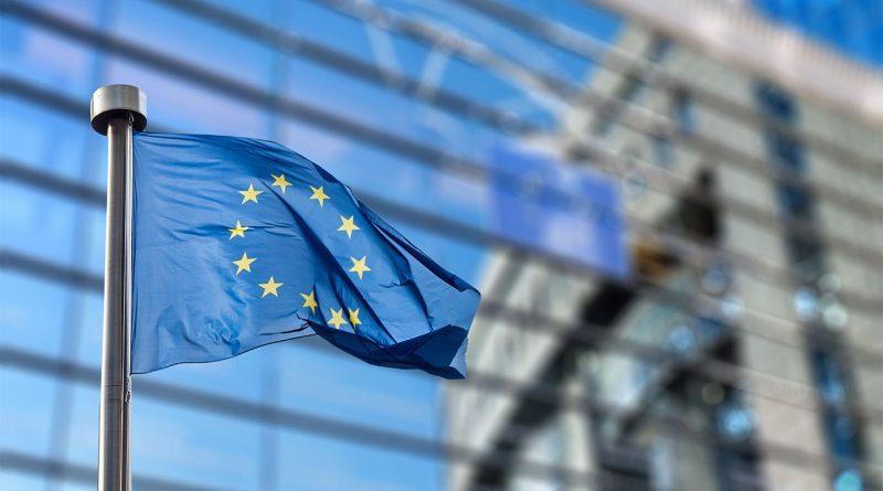 EU flag in front of parliament building to support Clean Industrial Deal article