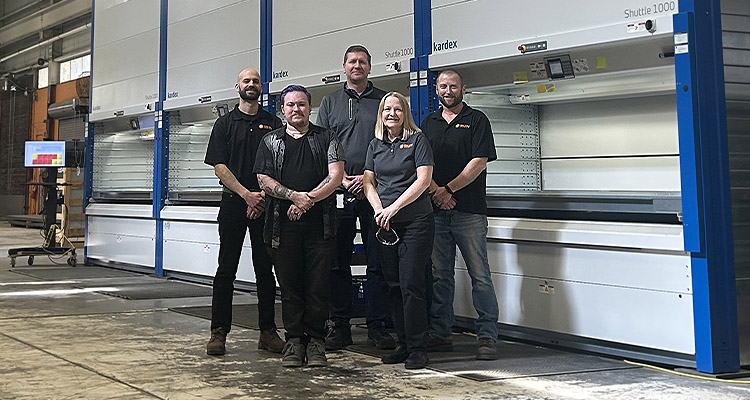 Sun Automation staff in front of Kardex Remstar vertical lift
