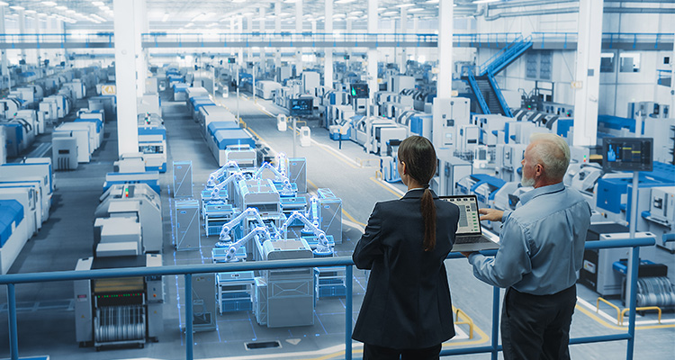 Male and Female Standing at Electronics Factory, Using Computer