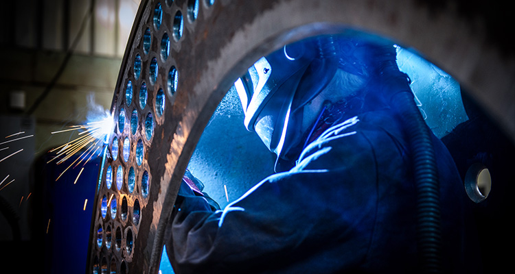welder working on a large metal structure