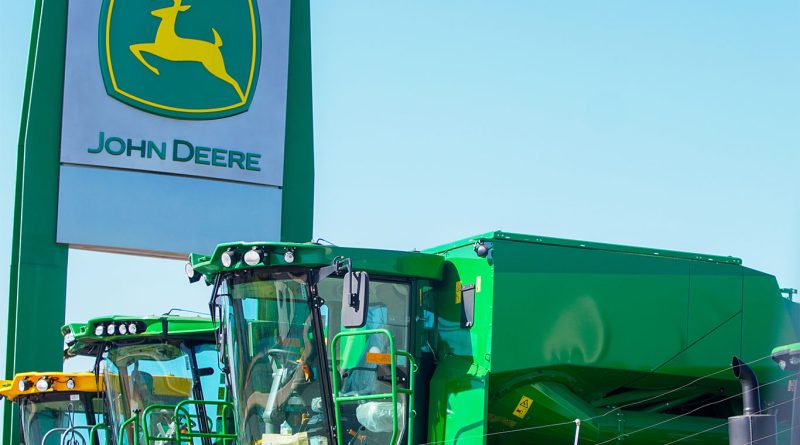 John Deere manufacturing facility with idle farm equipment lined up