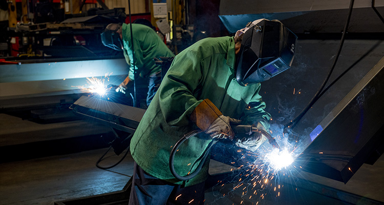two individuals engaged in welding