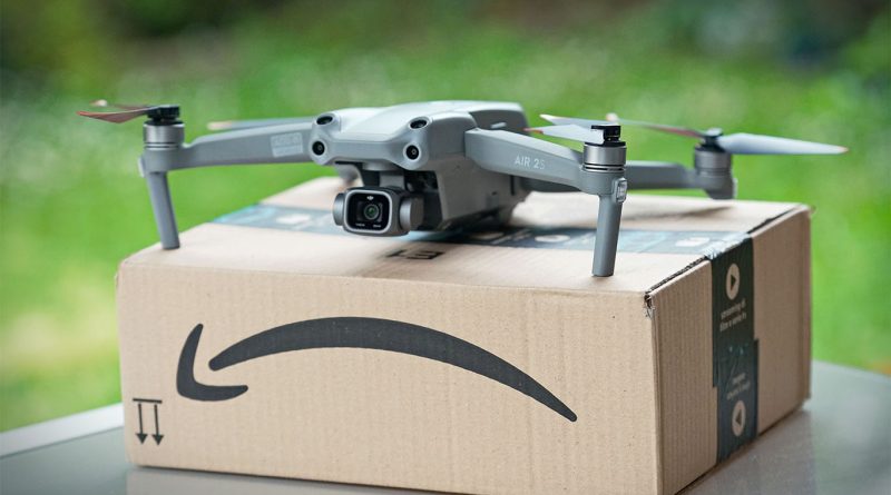 A drone carrying a small package flying above suburban rooftops in the US