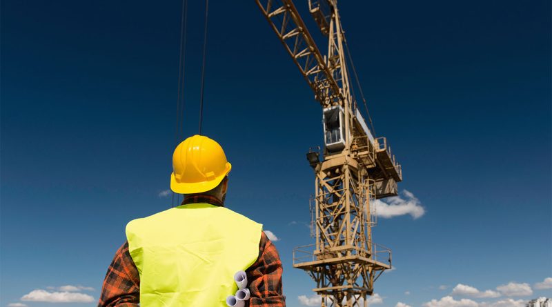 Construction worker stood looking at crane to support Crane Operator Training article