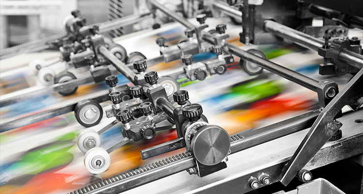 a close-up view of an offset printing machine in operation