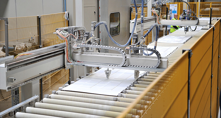 a manufacturing process for composite doors, featuring a robotic arm working on a door panel on a conveyor system