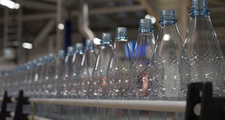 Petainer reusable PET plastic bottles on a production line.
