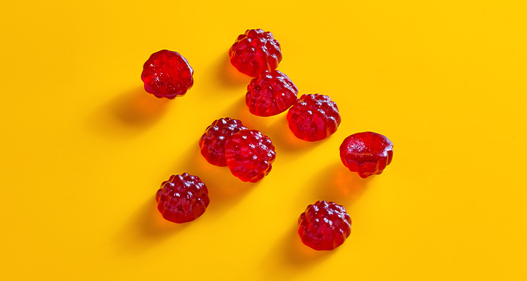red, berry-shaped gummies, which appear to be functional gummy supplements manufactured by TopGum.