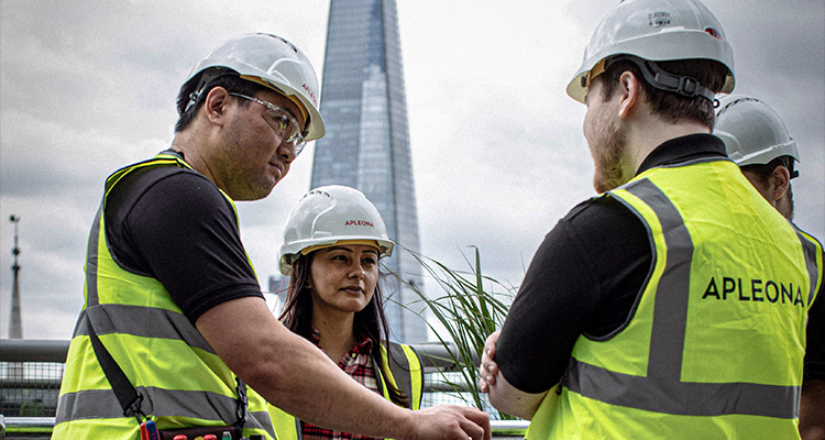 construction or site workers, wearing hard hats and high-visibility vests