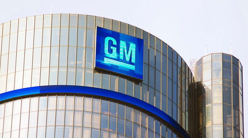 General Motors electric vehicles on display at an auto show as the company announces a $1.6 billion write-down.