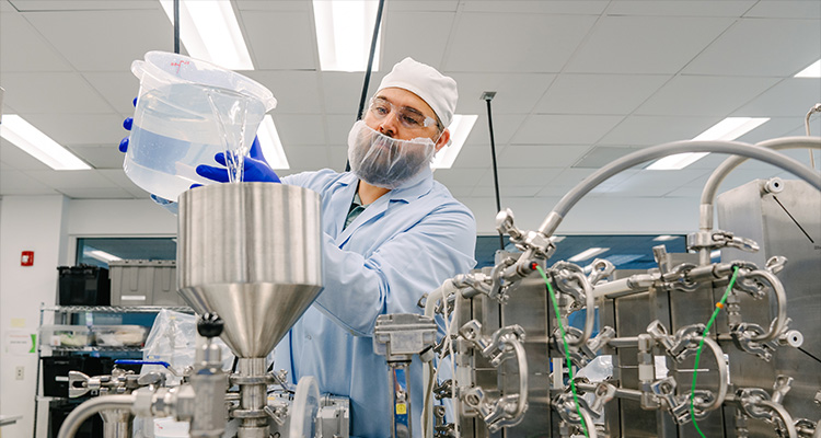 a person working in a pharmaceutical manufacturing facility