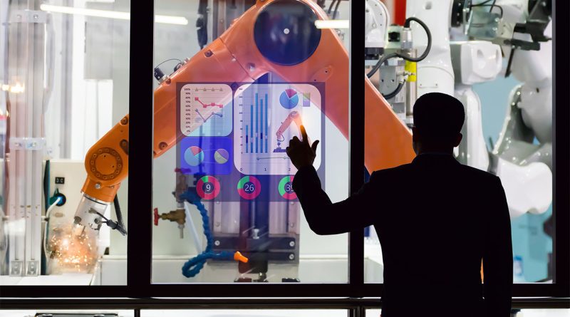 Students working on advanced robotics and AI-driven manufacturing systems inside a university research lab