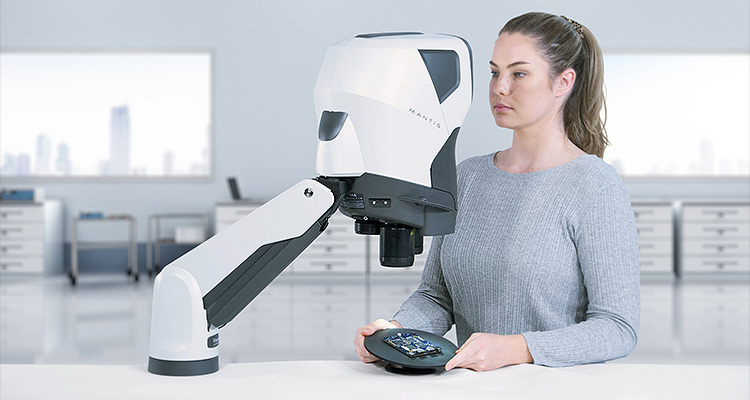 a woman using a Vision Engineering Mantis stereo microscope