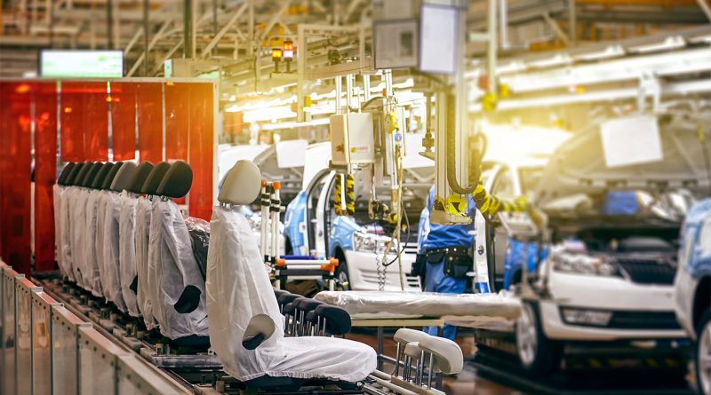 Workers assembling vehicles at a foreign automaker's US-based factory, symbolizing the shift toward local production.
