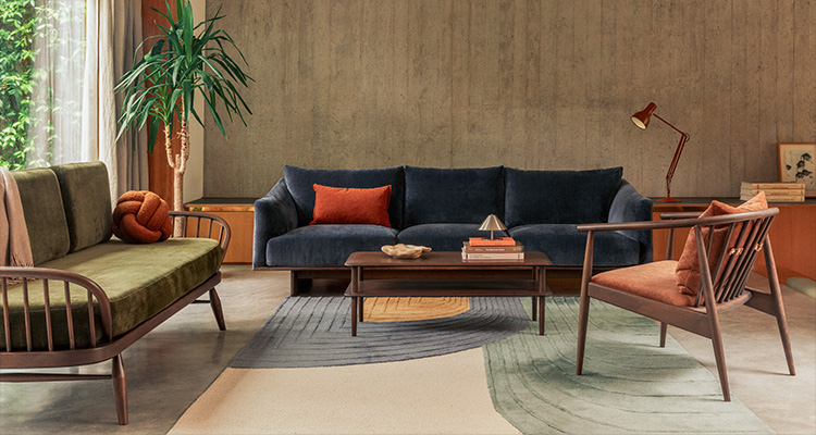 a three-seater sofa with a dark blue upholstery and a red cushion
