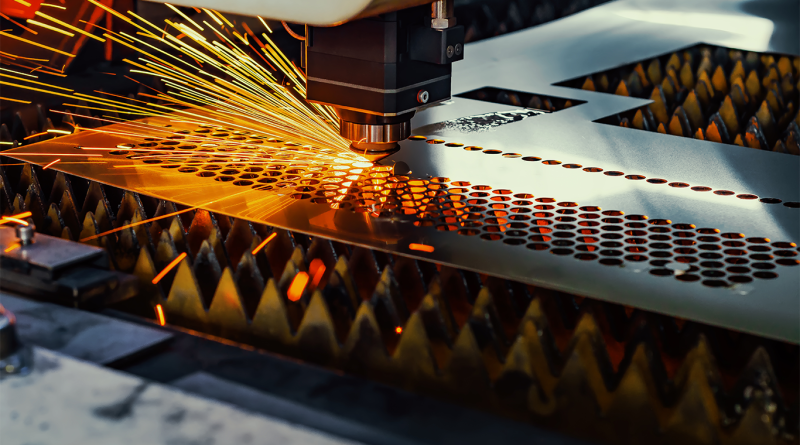 Laser cutting machine precisely cutting a metal sheet, with bright sparks flying in an advanced manufacturing environment.