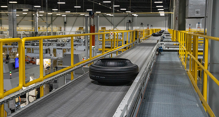 a tire being moved along an industrial conveyor system