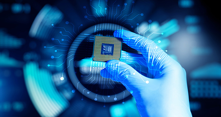 a hand in a blue glove holding a semiconductor microchip or integrated circuit