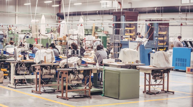 A dimly lit American factory with empty assembly lines, symbolizing the decline of U.S. manufacturing