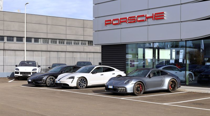 Porsche service technician updates driver assistance software on a 2025 Taycan at a dealership