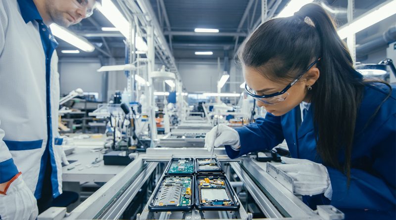 Factory workers monitor automated equipment in a US manufacturing facility during a shift in December 2025