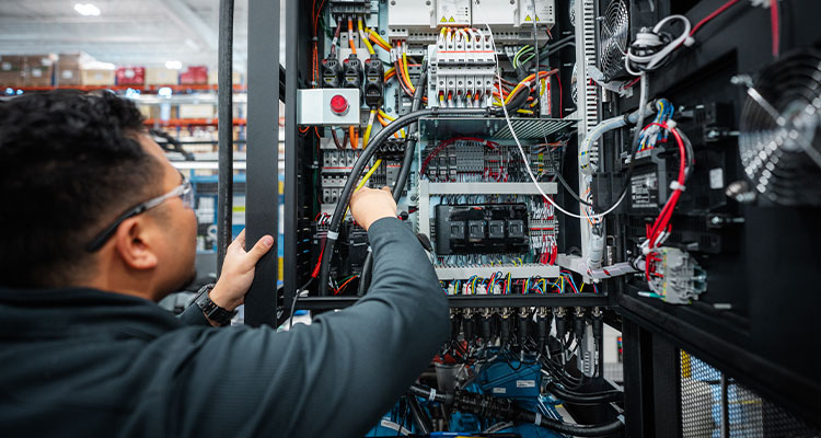 a technician working on electrical control panels and wiring